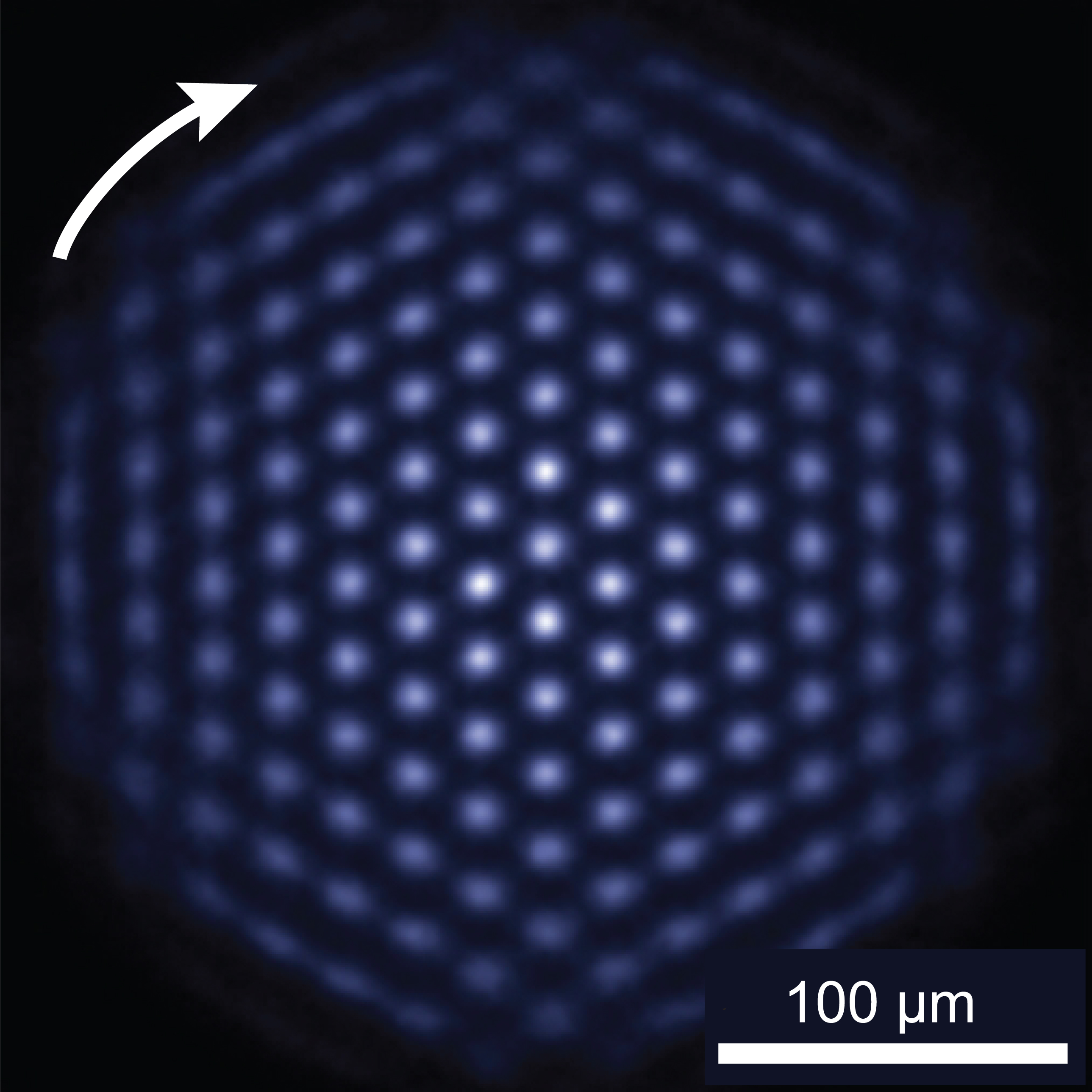 Top-view NIST photograph of fluorescing beryllium ions arranged in a triangular lattice inside a Penning trap